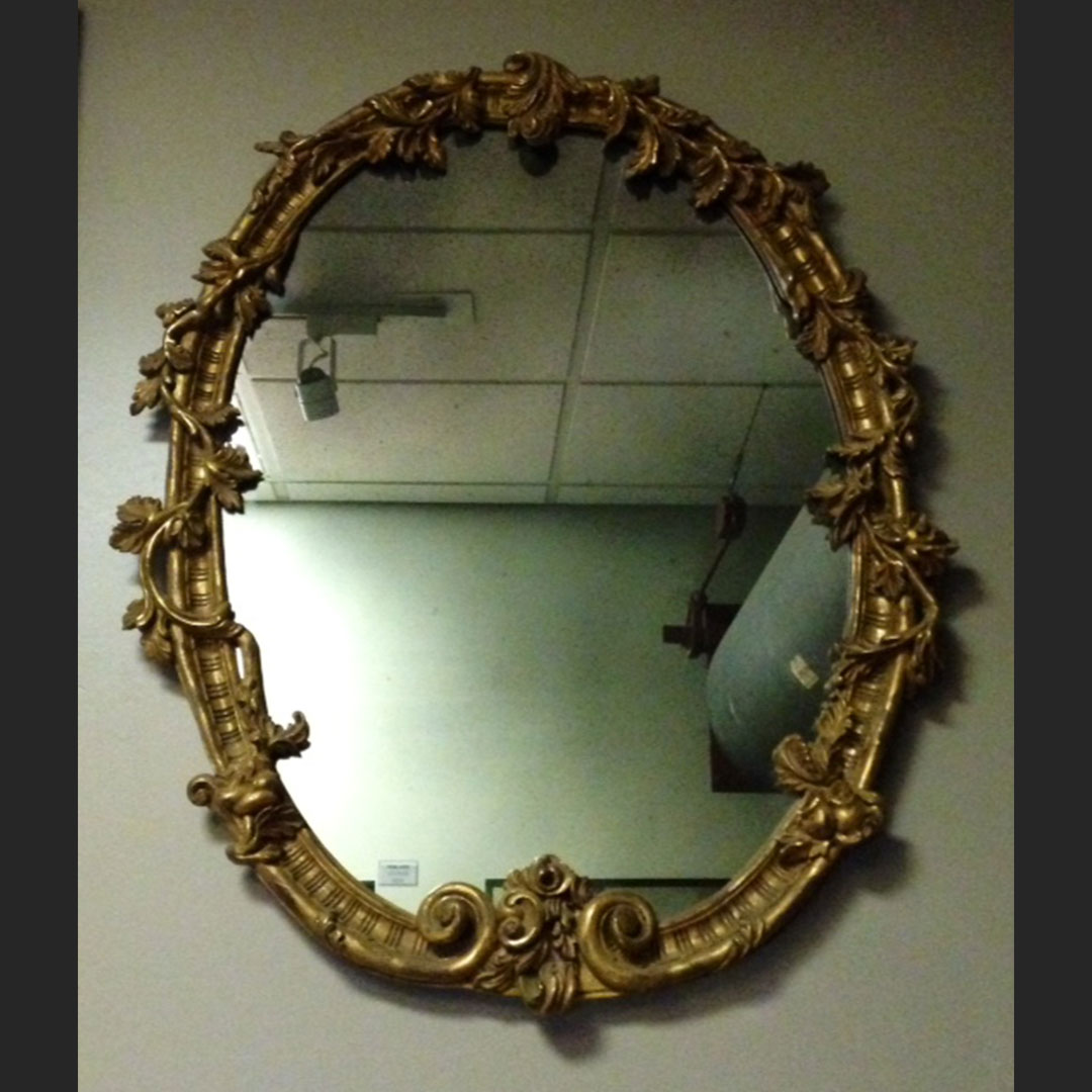 Hand-carved, round mirror designed by Lichten Craig Architecture & Interiors, fabricated entirely at Artmill Group's workrooms. Carved out of basswood, finished in 22k gold over a red bole with a matte black lip. This frame is shown with custom antique mirror.